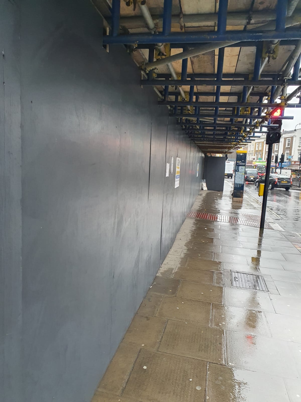Internal access route through a steel-framed building with a wet concrete floor